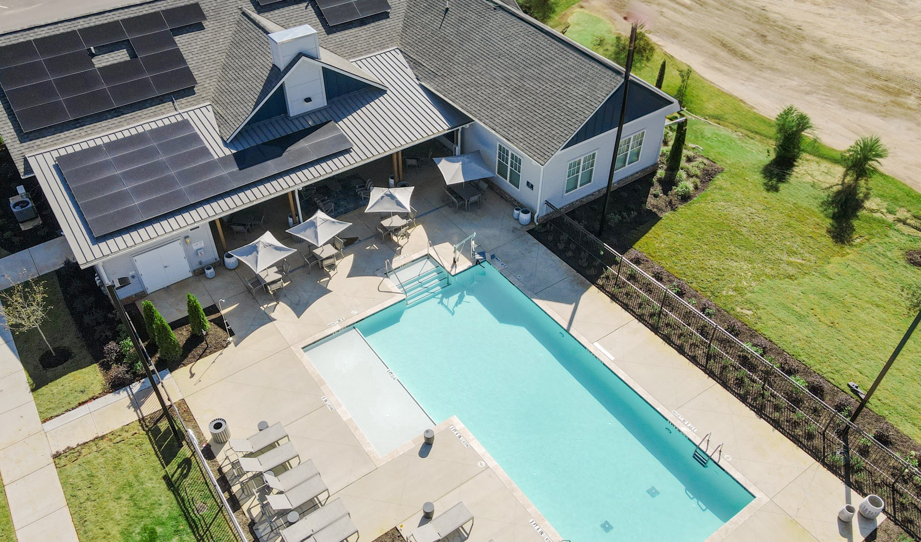 Aerial view of a pool and clubhouse building